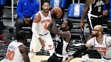 May 9, 2021; Los Angeles, California, USA; LA Clippers guard Patrick Beverley (21) drives to the basket between New York Knicks forward Julius Randle (30), guard Derrick Rose (4) and center Taj Gibson (67) during the first quarter. Mandatory Credit: Robert Hanashiro-USA TODAY Sports