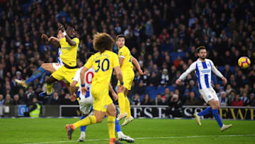 BRIGHTON, ENGLAND - DECEMBER 16: Lewis Dunk of Brighton and Hove Albion heads the ball wide under pressure from Antonio Ruediger of Chelsea during the Premier League match between Brighton & Hove Albion and Chelsea FC at American Express Community Stadium on December 16, 2018 in Brighton, United Kingdom. (Photo by Mike Hewitt/Getty Images)