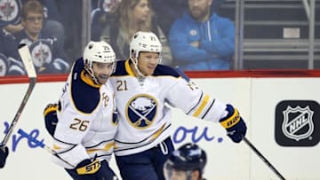 Oct 30, 2016; Winnipeg, Manitoba, CAN; Buffalo Sabres right wing Kyle Okposo (21) celebrates his second goal with teammates during the second period against Winnipeg Jets at MTS Centre. Mandatory Credit: Bruce Fedyck-USA TODAY Sports