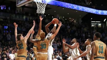 Feb 20, 2016; Atlanta, GA, USA; Georgia Tech Yellow Jackets guard Marcus Georges-Hunt (3) scores the game-winning basket in front of Notre Dame Fighting Irish guard Steve Vasturia (32), forward Bonzie Colson (35), and forward Zach Auguste (30) in the second half at McCamish Pavilion. The Yellow Jackets won 63-62. Mandatory Credit: Jason Getz-USA TODAY Sports