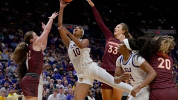 Nov 30, 2023; Baton Rouge, Louisiana, USA; LSU Lady Tigers forward Angel Reese (10) shoots against Virginia Tech Hokies guard Cayla King (22) and Virginia Tech Hokies center Elizabeth Kitley (33) during the first half at Pete Maravich Assembly Center. Mandatory Credit: Matthew Hinton-USA TODAY Sports