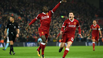 LIVERPOOL, ENGLAND - JANUARY 14: Sadio Mane of Liverpool celebrates with team mate Andy Robertson after scoring the third Liverpool goal during the Premier League match between Liverpool and Manchester City at Anfield on January 14, 2018 in Liverpool, England. (Photo by Shaun Botterill/Getty Images)