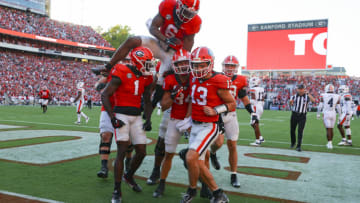 ATHENS, GA - OCTOBER 08: Stetson Bennett #13 of the Georgia Bulldogs reacts with teammates after scoring a touchdown in the second half against the Auburn Tigers at Sanford Stadium on October 8, 2022 in Athens, Georgia. (Photo by Todd Kirkland/Getty Images)