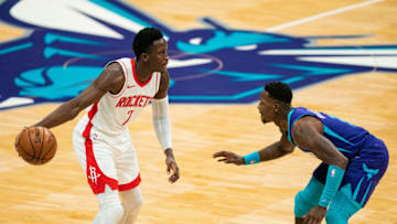 CHARLOTTE, NORTH CAROLINA - FEBRUARY 08: Victor Oladipo #7 of the Houston Rockets looks to pass the ball while guarded by Terry Rozier #3 of the Charlotte Hornets during the first quarter at Spectrum Center on February 08, 2021 in Charlotte, North Carolina. NOTE TO USER: User expressly acknowledges and agrees that, by downloading and or using this photograph, User is consenting to the terms and conditions of the Getty Images License Agreement. (Photo by Jacob Kupferman/Getty Images)