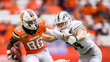 SYRACUSE, NY - SEPTEMBER 21: Trishton Jackson #86 of the Syracuse Orange sheds Anton Curtis #3 and Alex Grace #34 of the Western Michigan Broncos on his way to a touchdown during the third quarter at the Carrier Dome on September 21, 2019 in Syracuse, New York. Syracuse defeats Western Michigan 52-33. (Photo by Brett Carlsen/Getty Images)