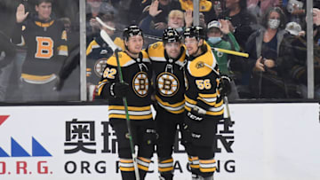 Oct 24, 2021; Boston, Massachusetts, USA; Boston Bruins left wing Jake DeBrusk (74) celebrates his goal with center Oskar Steen (62) and left wing Erik Haula (56) during the second period against the San Jose Sharks at TD Garden. Mandatory Credit: Bob DeChiara-USA TODAY Sports