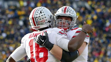 Nov 28, 2015; Ann Arbor, MI, USA; Ohio State Buckeyes quarterback J.T. Barrett (16) receives congratulations from offensive lineman Pat Elflein (65) in the fourth quarter against the Michigan Wolverines at Michigan Stadium. Mandatory Credit: Rick Osentoski-USA TODAY Sports