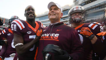 BLACKSBURG, VA - NOVEMBER 26: Head coach of the Virginia Tech Hokies Justin Fuente celebrates with cornerback Brandon Facyson