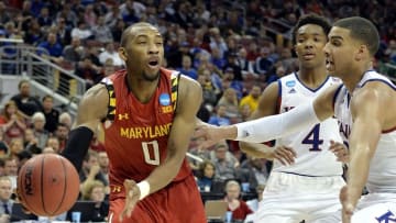 Mar 24, 2016; Louisville, KY, USA; Maryland Terrapins guard Rasheed Sulaimon (0) passes the ball against Kansas Jayhawks forward Landen Lucas (33) during the second half in a semifinal game in the South regional of the NCAA Tournament at KFC YUM!. Mandatory Credit: Jamie Rhodes-USA TODAY Sports