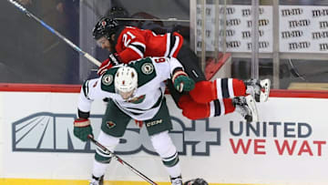 Oct 22, 2016; Newark, NJ, USA; Minnesota Wild defenseman Marco Scandella (6) hits New Jersey Devils right wing Kyle Palmieri (21) during the third period at Prudential Center. The Devils defeated the Wild 2-1 in overtime. Mandatory Credit: Ed Mulholland-USA TODAY Sports