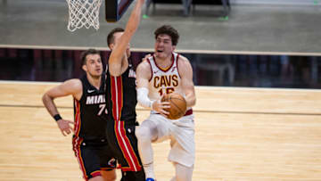 Apr 3, 2021; Miami, Florida, USA; Cleveland Cavaliers forward Cedi Osman (16) attempts a layup past Miami Heat guard Duncan Robinson (55) during the second quarter of a game at American Airlines Arena. Mandatory Credit: Mary Holt-USA TODAY Sports