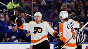 Jan 22, 2022; Buffalo, New York, USA; Philadelphia Flyers defenseman Rasmus Ristolainen (70) celebrates his goal with defenseman Travis Sanheim (6) during the first period against the Buffalo Sabres at KeyBank Center. Mandatory Credit: Timothy T. Ludwig-USA TODAY Sports