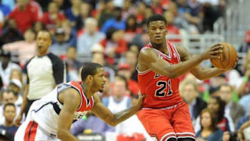Apr 27, 2014; Washington, DC, USA; Chicago Bulls shooting guard Jimmy Butler (21) is defended by Washington Wizards small forward Trevor Ariza (1) during the first quarter in game four of the first round of the 2014 NBA Playoffs at Verizon Center. Mandatory Credit: Brad Mills-USA TODAY Sports