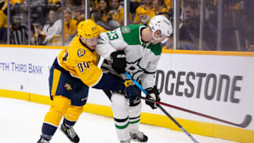 Tanner Jeannot #84 of the Nashville Predators and Esa Lindell #23 of the Dallas Stars vie for the puck during the first period at Bridgestone Arena on October 13, 2022 in Nashville, Tennessee. (Photo by Brett Carlsen/Getty Images)