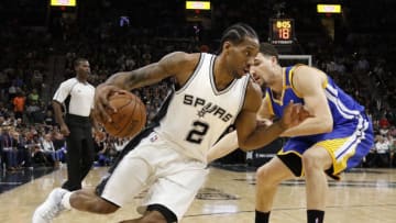 SAN ANTONIO,TX - MARCH 29: Kawhi Leonard #2 of the San Antonio Spurs drives on Klay Thompson #11 of the Golden State Warriors at AT&T Center on March 29, 2017 in San Antonio, Texas. NOTE TO USER: User expressly acknowledges and agrees that , by downloading and or using this photograph, User is consenting to the terms and conditions of the Getty Images License Agreement. (Photo by Ronald Cortes/Getty Images)