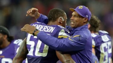Sep 29, 2013; London, UNITED KINGDOM; Minnesota Vikings coach Leslie Frazier (right) and linebacker Erin Henderson (50) embrace at the end of the NFL International Series game against the Pittsburgh Steelers at Wembley Stadium. The Vikings defeated the Steelers 34-27. Mandatory Credit: Kirby Lee-USA TODAY Sports