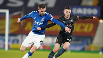 Everton's Icelandic midfielder Gylfi Sigurdsson (L) vies with Manchester City's English midfielder Phil Foden during the English Premier League football match between Everton and Manchester United at Goodison Park in Liverpool, north west England on February 17, 2021. (Photo by Jon Super / POOL / AFP) / RESTRICTED TO EDITORIAL USE. No use with unauthorized audio, video, data, fixture lists, club/league logos or 'live' services. Online in-match use limited to 120 images. An additional 40 images may be used in extra time. No video emulation. Social media in-match use limited to 120 images. An additional 40 images may be used in extra time. No use in betting publications, games or single club/league/player publications. / (Photo by JON SUPER/POOL/AFP via Getty Images)