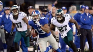 Dec 28, 2014; East Rutherford, NJ, USA; New York Giants wide receiver Odell Beckham (13) gets past Philadelphia Eagles free safety Malcolm Jenkins (27) to score a touchdown during the game at MetLife Stadium. Mandatory Credit: Robert Deutsch-USA TODAY Sports
