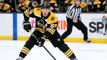 Apr 11, 2021; Boston, Massachusetts, USA; Boston Bruins left wing Brad Marchand (63) looks to pass the puck during the first period against the Washington Capitals at TD Garden. Mandatory Credit: Paul Rutherford-USA TODAY Sports