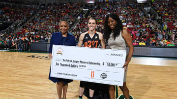 SEATTLE, WA - JULY 22: WNBA President Lisa Borders presents a check to Allie Quigley