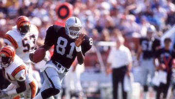 LOS ANGELES,CA-CIRCA 1988:Tim Brown of the Los Angeles Raiders rushes against the Cincinnati Bengals at the Coliseum circa 1988 in Los Angeles,California. (Photo by Owen Shaw/Getty Images)
