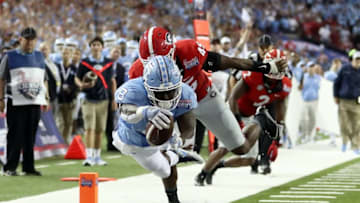Sep 3, 2016; Atlanta, GA, USA; North Carolina Tar Heels running back T.J. Logan (8) dives for a touchdown against Georgia Bulldogs linebacker Reggie Carter (45) during the third quarter of the 2016 Chick-Fil-A Kickoff game at Georgia Dome. Mandatory Credit: Jason Getz-USA TODAY Sports