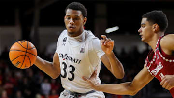 Cincinnati Bearcats forward Ody Oguama dribbles against Temple Owls forward Nick Jourdain at Fifth Third Arena. USA Today.