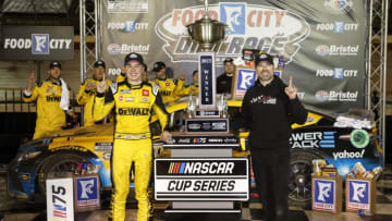 BRISTOL, TENNESSEE - APRIL 09: Christopher Bell, driver of the #20 DeWalt Power Stack Toyota, and crew chief Adam Stevens celebrate in victory lane after winning the NASCAR Cup Series Food City Dirt Race at Bristol Motor Speedway on April 09, 2023 in Bristol, Tennessee. (Photo by Jared C. Tilton/Getty Images)