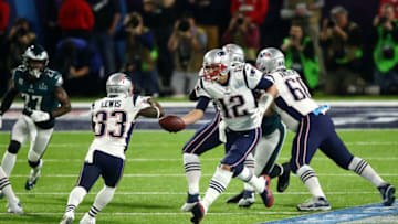 MINNEAPOLIS, MN - FEBRUARY 04: Tom Brady #12 hands the ball offsides to Dion Lewis #33 of the New England Patriots against the Philadelphia Eagles in the first quarter of Super Bowl LII at U.S. Bank Stadium on February 4, 2018 in Minneapolis, Minnesota. (Photo by Gregory Shamus/Getty Images)