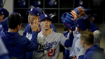 MILWAUKEE, WI - OCTOBER 20: Walker Buehler #21 of the Los Angeles Dodgers walks in the dugout after being relieved against the Milwaukee Brewers during the fifth inning in Game Seven of the National League Championship Series at Miller Park on October 20, 2018 in Milwaukee, Wisconsin. (Photo by Jonathan Daniel/Getty Images)