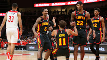 Nov 1, 2021; Atlanta, Georgia, USA; Atlanta Hawks guard Lou Williams (6) and forward Cam Reddish (22) help up guard Trae Young (11) against the Washington Wizards in the second half at State Farm Arena. Mandatory Credit: Brett Davis-USA TODAY Sports