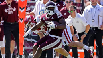 STARKVILLE, MISSISSIPPI - OCTOBER 08: Jo'quavious Marks #7 of the Mississippi State Bulldogs carries the ball against Hudson Clark #17 of the Arkansas Razorbacks during the game at Davis Wade Stadium on October 08, 2022 in Starkville, Mississippi. (Photo by Justin Ford/Getty Images)