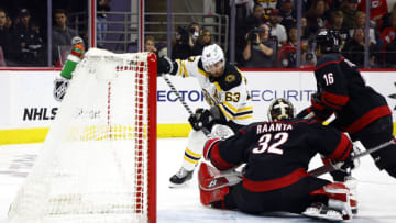 RALEIGH, NORTH CAROLINA - MAY 10: Antti Raanta #32 of the Carolina Hurricanes makes a first period save against Brad Marchand #63 of the Boston Bruins in Game Five of the First Round of the 2022 Stanley Cup Playoffs at PNC Arena on May 10, 2022 in Raleigh, North Carolina. (Photo by Jared C. Tilton/Getty Images)