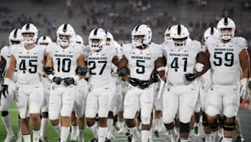 TEMPE, AZ - SEPTEMBER 08: The Michigan State Spartans walk arm in arm onto the field before the college football game against the Arizona State Sun Devils at Sun Devil Stadium on September 8, 2018 in Tempe, Arizona. (Photo by Christian Petersen/Getty Images)