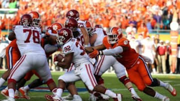 Dec 31, 2015; Miami Gardens, FL, USA; Oklahoma Sooners running back Samaje Perine (32) runs the ball against Clemson Tigers defensive end Kevin Dodd (98) during the first half of the 2015 CFP semifinal at the Orange Bowl at Sun Life Stadium. Mandatory Credit: Steve Mitchell-USA TODAY Sports