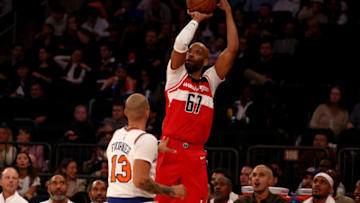 NEW YORK, NEW YORK - OCTOBER 18: Taj Gibson #67 of the Washington Wizards shoots a three point shot over Evan Fournier #13 of the New York Knicks during a preseason game at Madison Square Garden on October 18, 2023 in New York City. NOTE TO USER: User expressly acknowledges and agrees that, by downloading and or using this photograph, User is consenting to the terms and conditions of the Getty Images License Agreement. (Photo by Elsa/Getty Images)