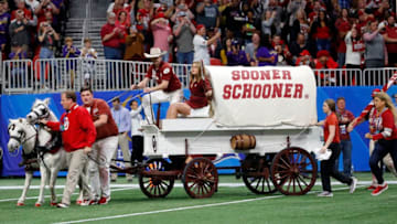 ATLANTA, GEORGIA - DECEMBER 28: Oklahoma Sooners animal mascots Boomer and Sooner pulling Sooner Schooner Conestoga wagon on the field before the game against the LSU Tigers in the Chick-fil-A Peach Bowl at Mercedes-Benz Stadium on December 28, 2019 in Atlanta, Georgia. (Photo by Kevin C. Cox/Getty Images)