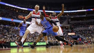 Jan 21, 2015; Washington, DC, USA; Oklahoma City Thunder guard Reggie Jackson (15) dribbles the ball as Washington Wizards center Marcin Gortat (4) and Wizards guard John Wall (2) defend in the third quarter at Verizon Center. The Thunder won 105-103 in overtime. Mandatory Credit: Geoff Burke-USA TODAY Sports