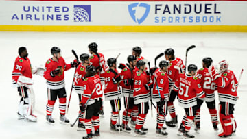 Jan 22, 2021; Chicago, Illinois, USA; The Chicago Blackhawks react after defeating the Detroit Red Wings at the United Center. Mandatory Credit: Mike Dinovo-USA TODAY Sports