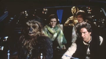 British actors Peter Mayhew, Anthony Daniels, American Carrie Fisher and Harrison Ford on the set of Star Wars: Episode VI - Return of the Jedi directed by Welsh Richard Marquand. (Photo by Sunset Boulevard/Corbis via Getty Images)