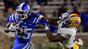 DURHAM, NORTH CAROLINA - OCTOBER 05: Deon Jackson #25 of the Duke Blue Devils stiff-arms Cam Bright #38 of the Pittsburgh Panthers during the second half of their game at Wallace Wade Stadium on October 05, 2019 in Durham, North Carolina. Pittsburgh won 33-30. (Photo by Grant Halverson/Getty Images)