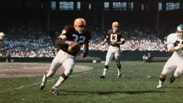 (Original Caption) Jim Brown (32) has just taken hand off from Quarterback Frank Ryan (13) in game against the Philadelphia Eagles.