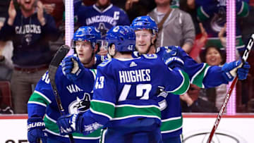 VANCOUVER, BC - MARCH 28: Brock Boeser #6 of the Vancouver Canucks is congratulated by teammates Quinn Hughes #43 an d Elias Pettersson #40 after scoring during their NHL game against the Los Angeles Kings at Rogers Arena March 28, 2019 in Vancouver, British Columbia, Canada. Vancouver won 3-2. (Photo by Jeff Vinnick/NHLI via Getty Images)
