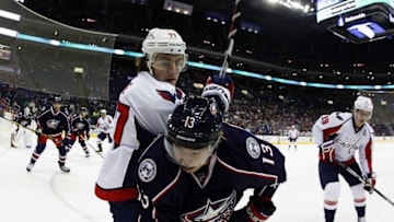 Jan 19, 2016; Columbus, OH, USA; Washington Capitals right wing T.J. Oshie (77) tries to free the puck from Columbus Blue Jackets right wing Cam Atkinson (13) during the first period at Nationwide Arena. Mandatory Credit: Russell LaBounty-USA TODAY Sports