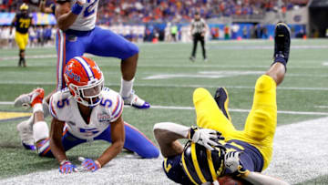 ATLANTA, GEORGIA - DECEMBER 29: Tarik Black #7 of the Michigan Wolverines drops a pass under pressure from CJ Henderson #5 of the Florida Gators in the fourth quarter during the Chick-fil-A Peach Bowl at Mercedes-Benz Stadium on December 29, 2018 in Atlanta, Georgia. (Photo by Joe Robbins/Getty Images)