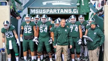 Nov 28, 2015; East Lansing, MI, USA; Michigan State Spartans head coach Mark Dantonio leads his team onto the field prior to a game against the Penn State Nittany Lions at Spartan Stadium. Mandatory Credit: Mike Carter-USA TODAY Sports