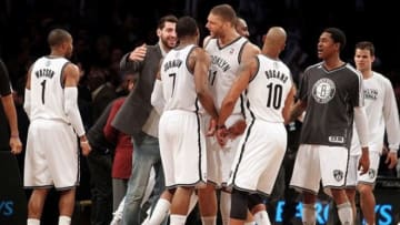 Feb 19, 2013; Brooklyn, NY, USA; Brooklyn Nets guard Joe Johnson (7) is congratulated by teammates after tying the game at the buzzer to end the fourth quarter of an NBA game against the Milwaukee Bucks at Barclays Center. Mandatory Credit: Brad Penner-USA TODAY Sports