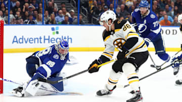 Mar 3, 2020; Tampa, Florida, USA; Boston Bruins right wing David Pastrnak (88) shoots as Tampa Bay Lightning goaltender Andrei Vasilevskiy (88) makes a save during the second period at Amalie Arena. Mandatory Credit: Kim Klement-USA TODAY Sports