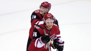 Feb 18, 2016; Glendale, AZ, USA; Arizona Coyotes right wing Shane Doan (19) and center Max Domi (16) celebrate after beating the Dallas Stars 6-3 at Gila River Arena. Mandatory Credit: Matt Kartozian-USA TODAY Sports