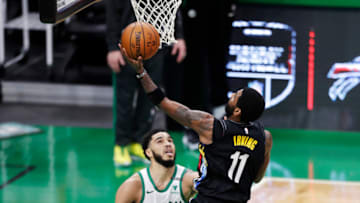 BOSTON, MASSACHUSETTS - DECEMBER 25: Kyrie Irving #11 of the Brooklyn Nets drives to the basket during the third quarter of the game against the Boston Celtics at TD Garden on December 25, 2020 in Boston, Massachusetts. NOTE TO USER: User expressly acknowledges and agrees that, by downloading and or using this photograph, User is consenting to the terms and conditions of the Getty Images License Agreement. (Photo by Omar Rawlings/Getty Images)